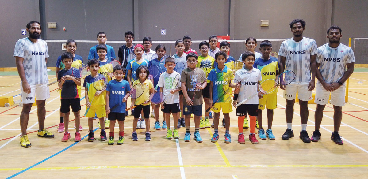 Young shuttlers with their coaches at the New Vision Badminton Sport academy in Doha.