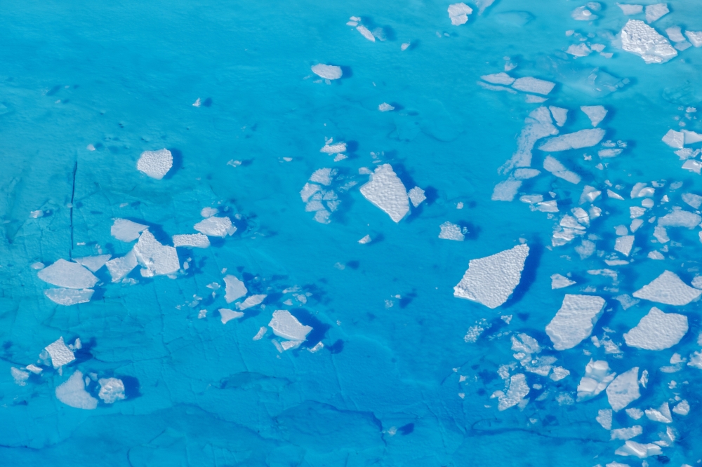 Chunks of ice float inside of meltwater pools on top of the Helheim glacier near Tasiilaq, Greenland, June 19, 2018. REUTERS/Lucas Jackson/File Photo/File Photo