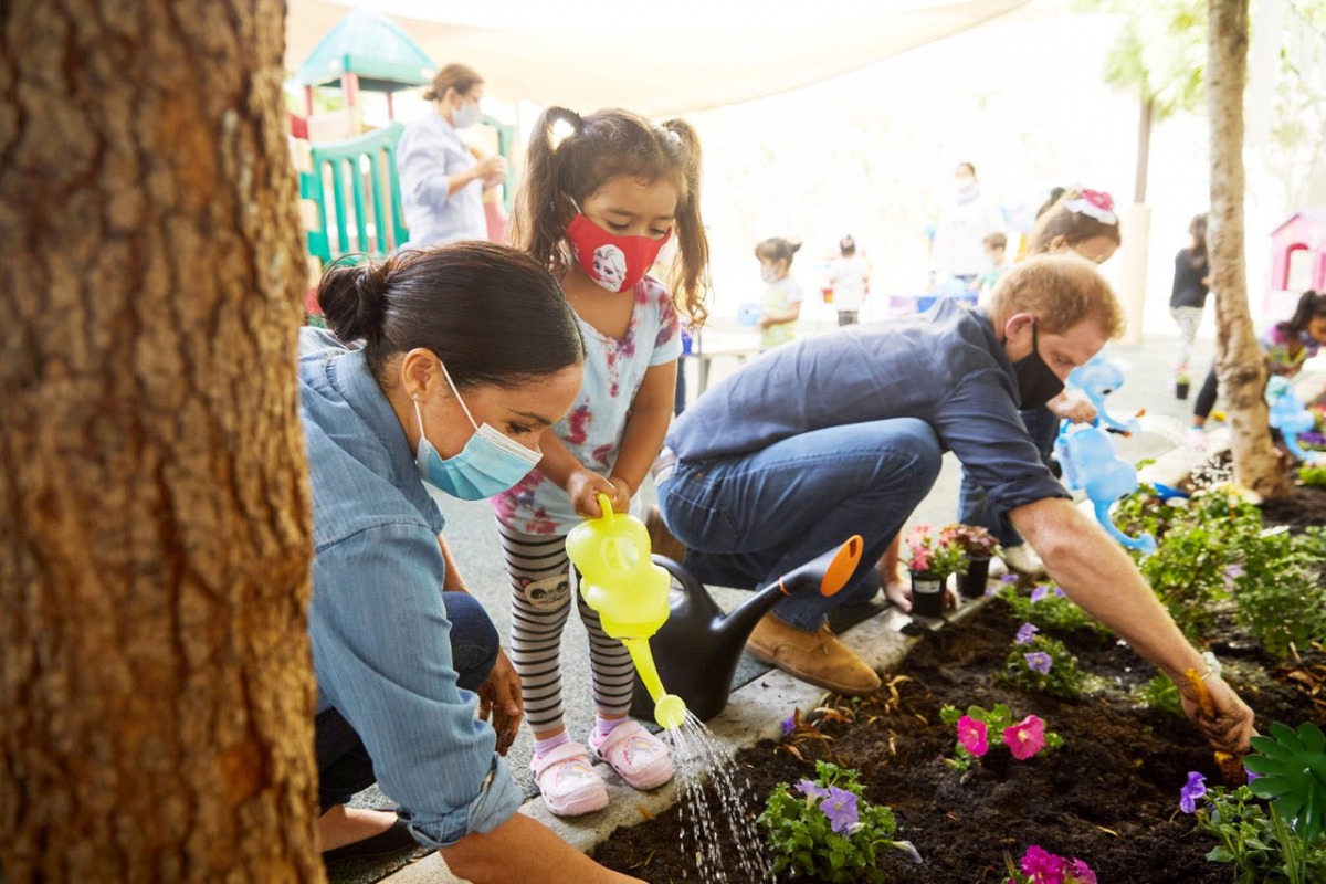 Prince Harry and Meghan Markle, the Duke and Duchess of Sussex, plant flowers and forget-me-nots during a visit to the Assistance League Los Angeles' Preschool Learning Center in Los Angeles, California, U.S. August 31, 2020, in this picture obtained from