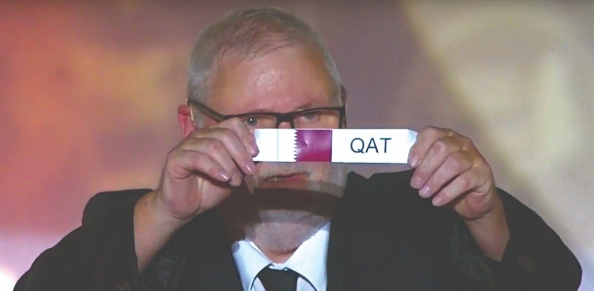 An official picks Qatar during the draw ceremony yesterday.