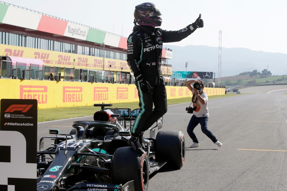 Mercedes' British driver Lewis Hamilton celebrates winning the pole position after the qualifying session at the Mugello circuit ahead of the Tuscany Formula One Grand Prix in Scarperia e San Piero on September 12, 2020. / AFP / POOL / Luca Bruno