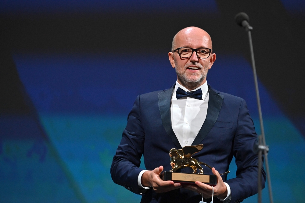 Disney's Marketing Director for Italy, Davide Romani acknowledges receiving the Golden Lion for Best Film on behalf of US director Chloe Zhao for 
