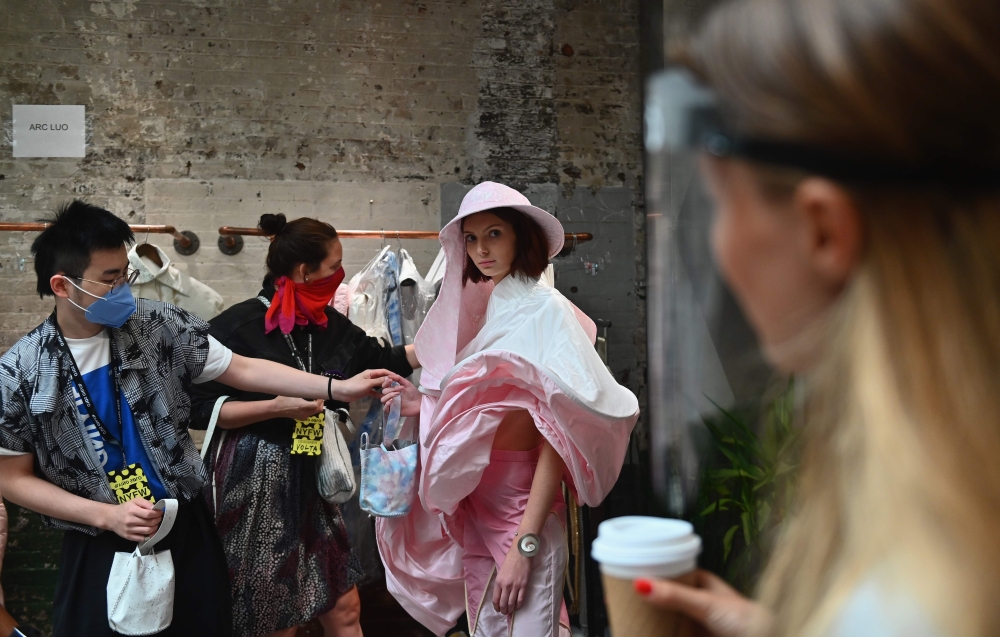A model gets fitted during a NYFW behind the scenes fitting day for the Flying Solo runway show featuring a collective of local designers on September 11, 2020 New York City. AFP / Angela Weiss
