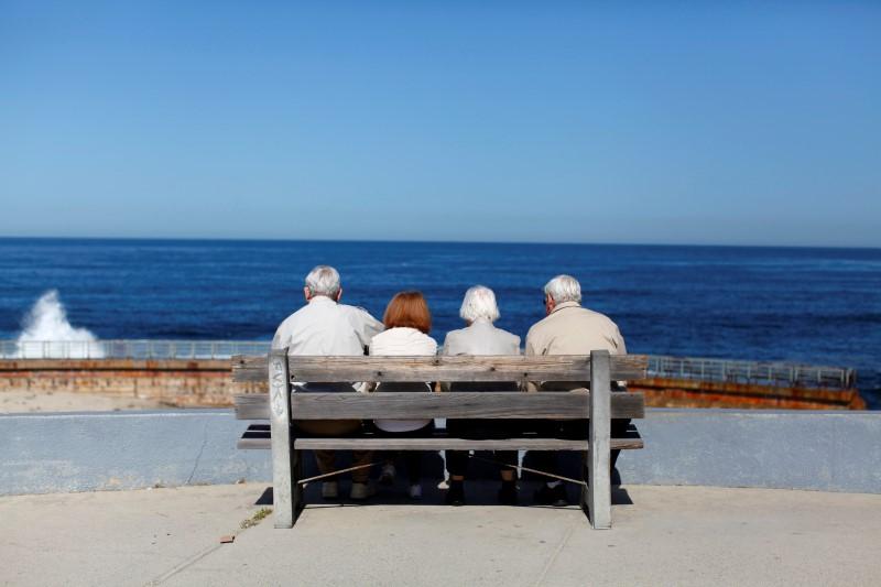 FILE PHOTO:A pair of elderly couples view the ocean and waves along the beach in La Jolla, California March 8, 2012. REUTERS/Mike Blake
