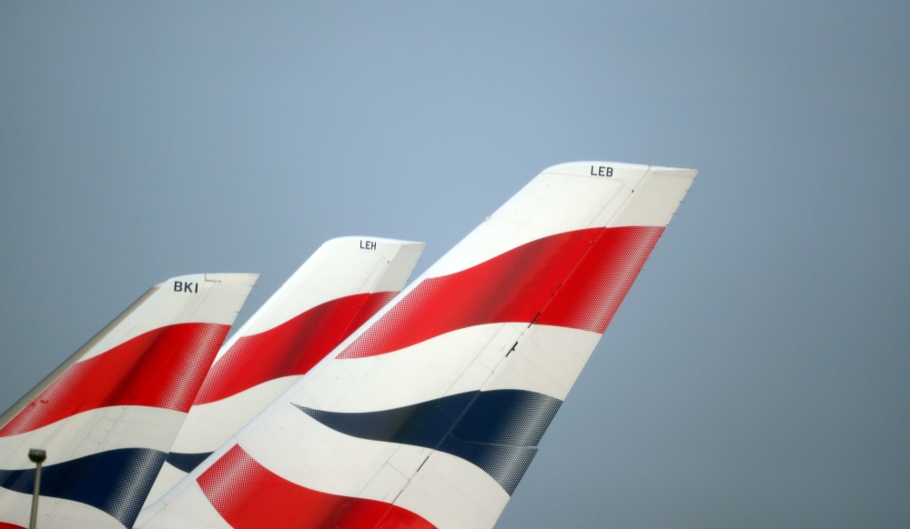FILE PHOTO: British Airways logos are seen on tail fins at Heathrow Airport in west London, Britain, February 23, 2018. REUTERS/Hannah McKay