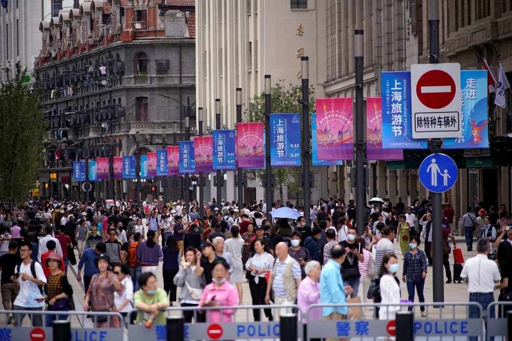 People visit a main shopping area following the coronavirus disease (COVID-19) outbreak in Shanghai, China September 24, 2020. REUTERS/Aly Song