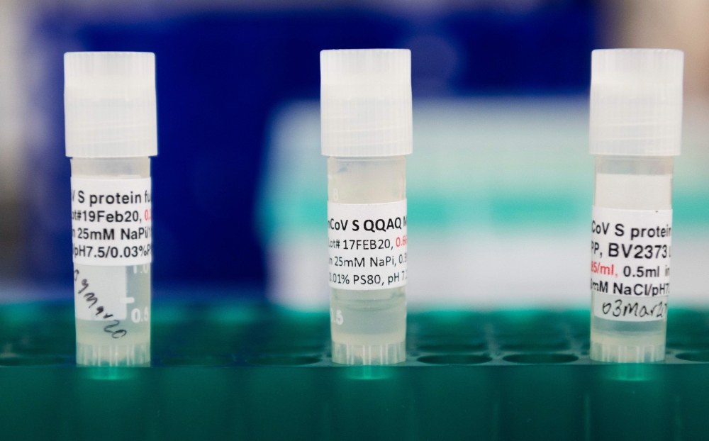 In this file photo three potential coronavirus, COVID-19, vaccines are kept in a tray at Novavax labs in Gaithersburg, Maryland on March 20, 2020, one of the labs developing a vaccine for the coronavirus, COVID-19. US biotech firm Novavax said Ton Septemb