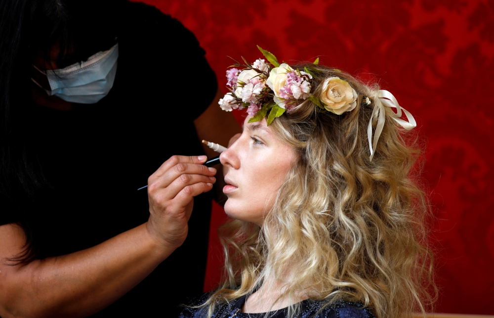 French model Tiffany Fournier has her make-up applied before posing for a digital presentation as part of the spring/summer 2021 collections for the Polish fashion house La Metamorphose, in Paris, France, September 26, 2020. Reuters/Charles Platiau