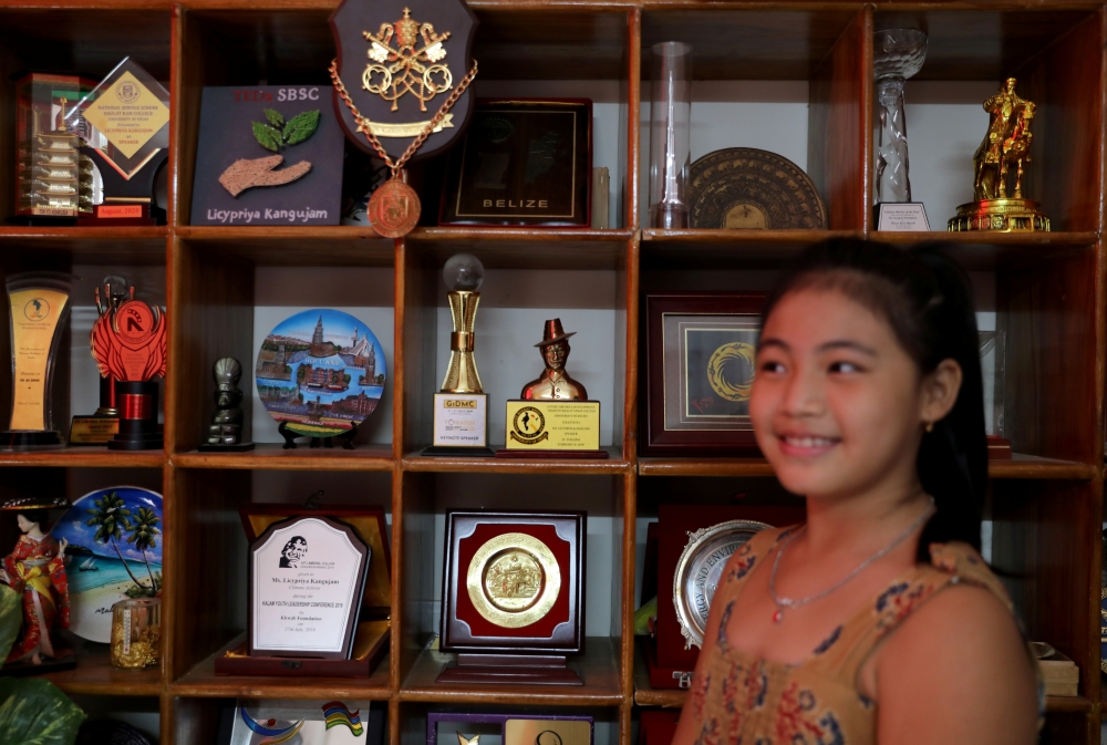 Licypriya Kangujam, 8, India's young climate activist, poses in front of her trophies at her house in Noida, on the outskirts of New Delhi, India, September 21, 2020. Picture taken September 21, 2020. Reuters/Anushree Fadnavis