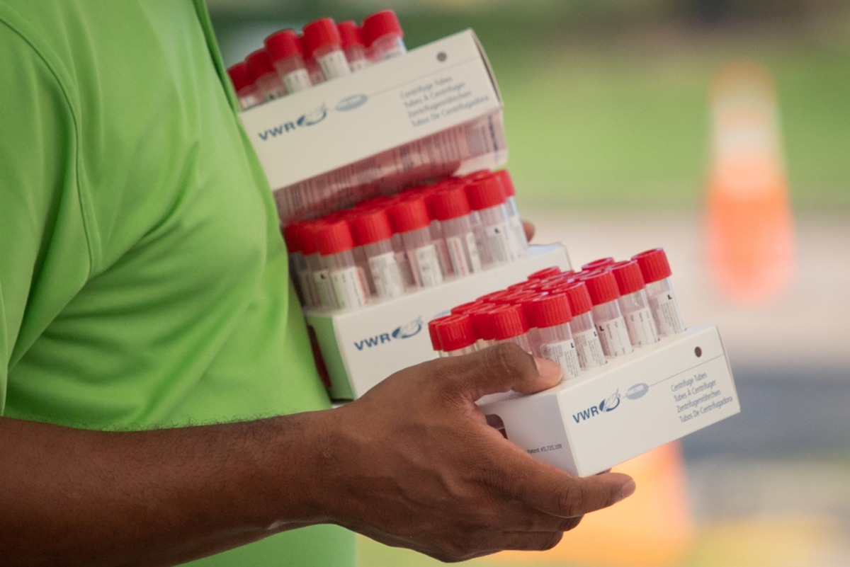 FILE PHOTO: A healthcare worker carries specimen collection tubes at a coronavirus disease (COVID-19) drive-in testing location in Houston, Texas, U.S., August 18, 2020. REUTERS/Adrees Latif/File Photo
