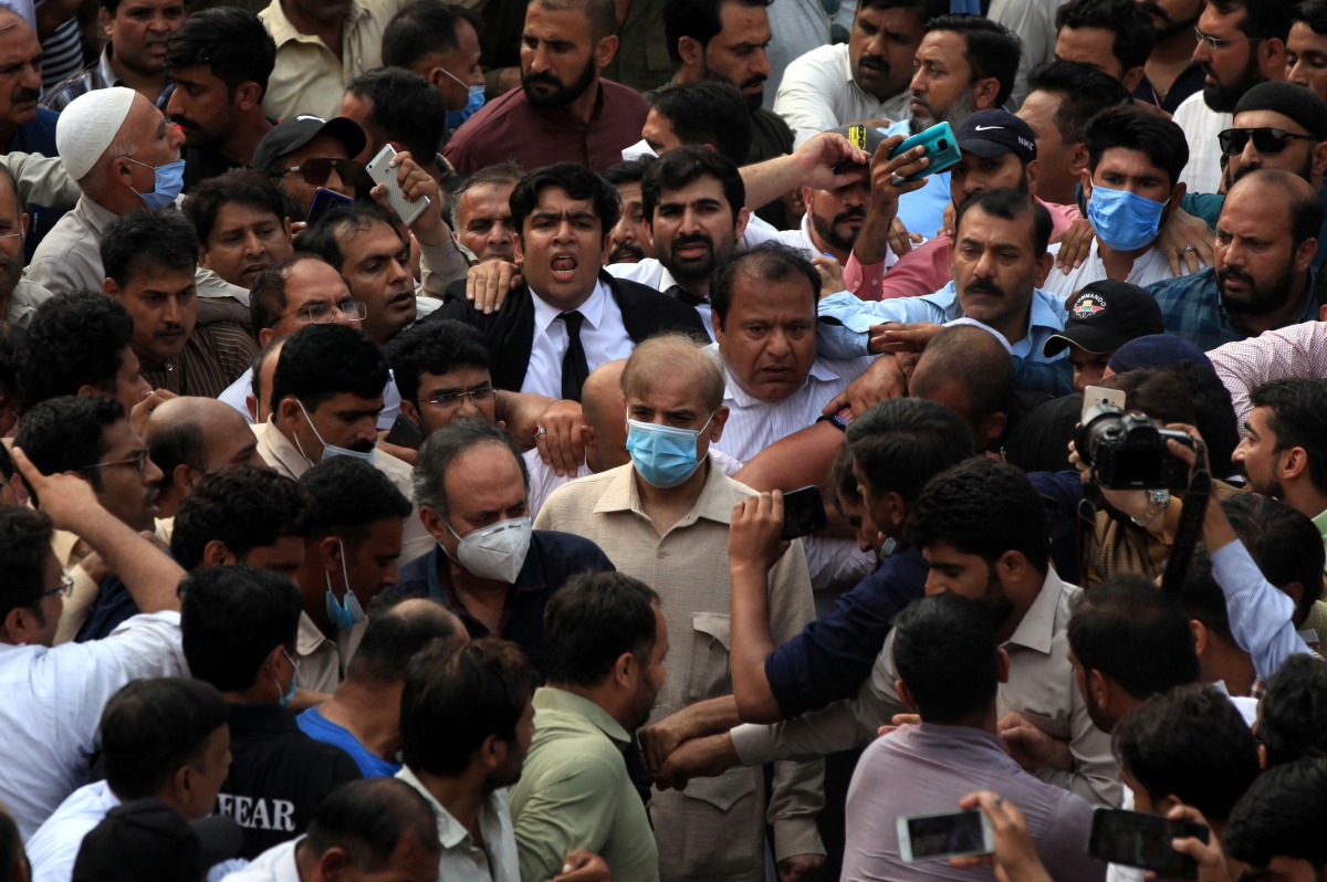 Shehbaz Sharif, brother of former Prime Minister Nawaz Sharif and leader of Pakistan Muslim League-Nawaz (PML-N), walks with lawyers and supporters after the High Court rejected bail plea in money laundering case in Lahore, Pakistan September 28, 2020. RE