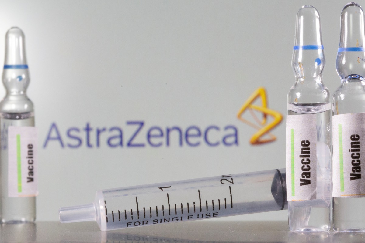 FILE PHOTO: A test-tube labelled vaccine is seen in front of AstraZeneca logo in this illustration taken, September 9, 2020. REUTERS/Dado Ruvic/Illustration/File Photo
