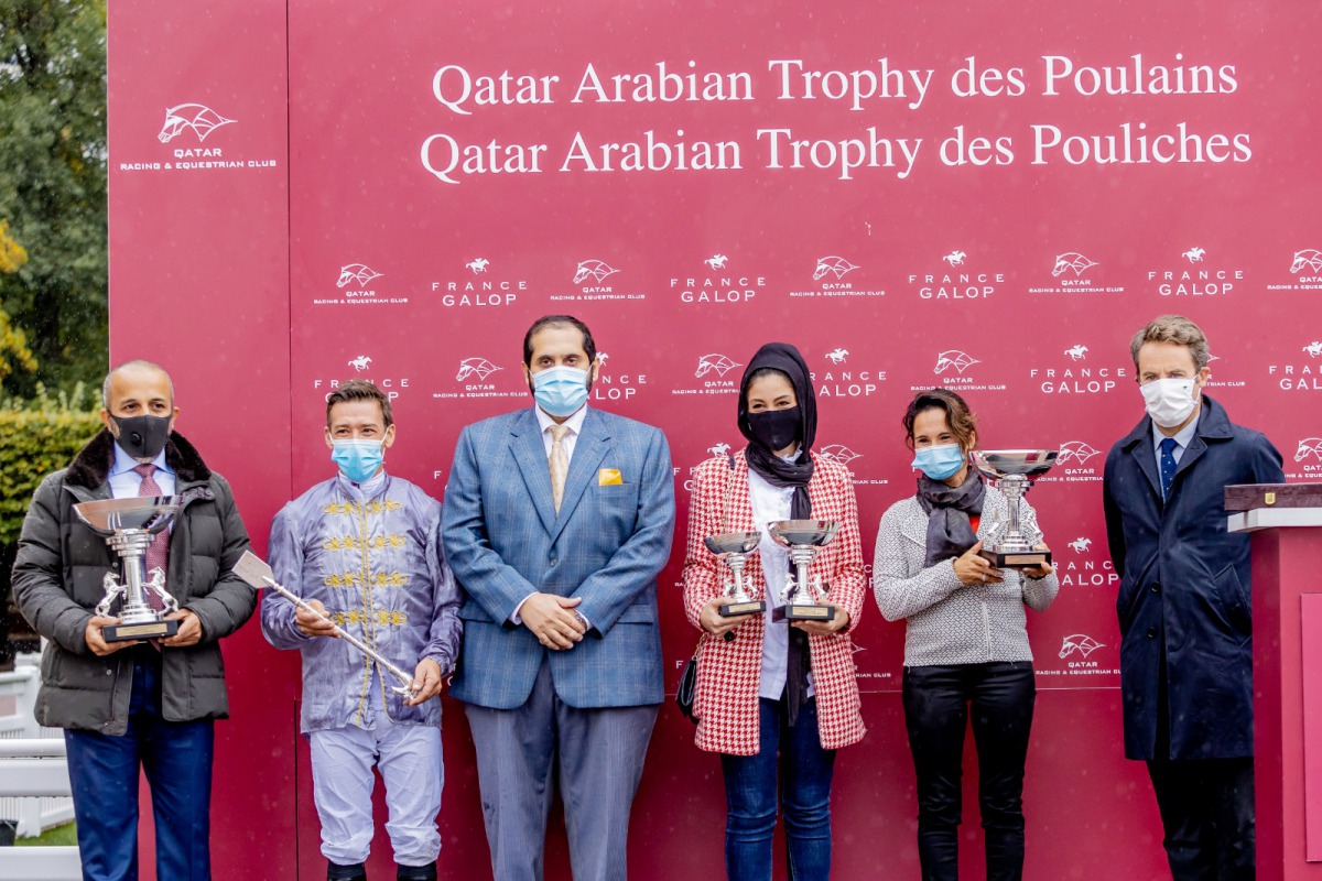 Qatar Racing and Equestrian Club CEO, Nasser bin Sherida Al Kaabi (centre) posing for a photograph with the winning team at St Cloud racetrack in France, yesterday.