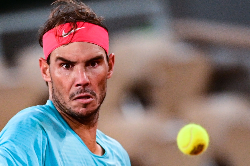 Spain's Rafael Nadal eyes the ball as he plays against Italy's Jannik Sinner during their men's singles quarter-final tennis match on Day 10 of The Roland Garros 2020 French Open tennis tournament in Paris on October 6, 2020. AFP / MARTIN BUREAU