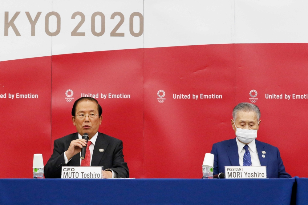 Tokyo 2020 Olympic Games CEO Toshiro Muto (L) speaks beside Tokyo 2020 Olympic Games president Yoshiro Mori during a press conference regarding the Tokyo Olympics, which have been postponed due to the COVID-19 novel coronavirus, in Tokyo on October 7, 202