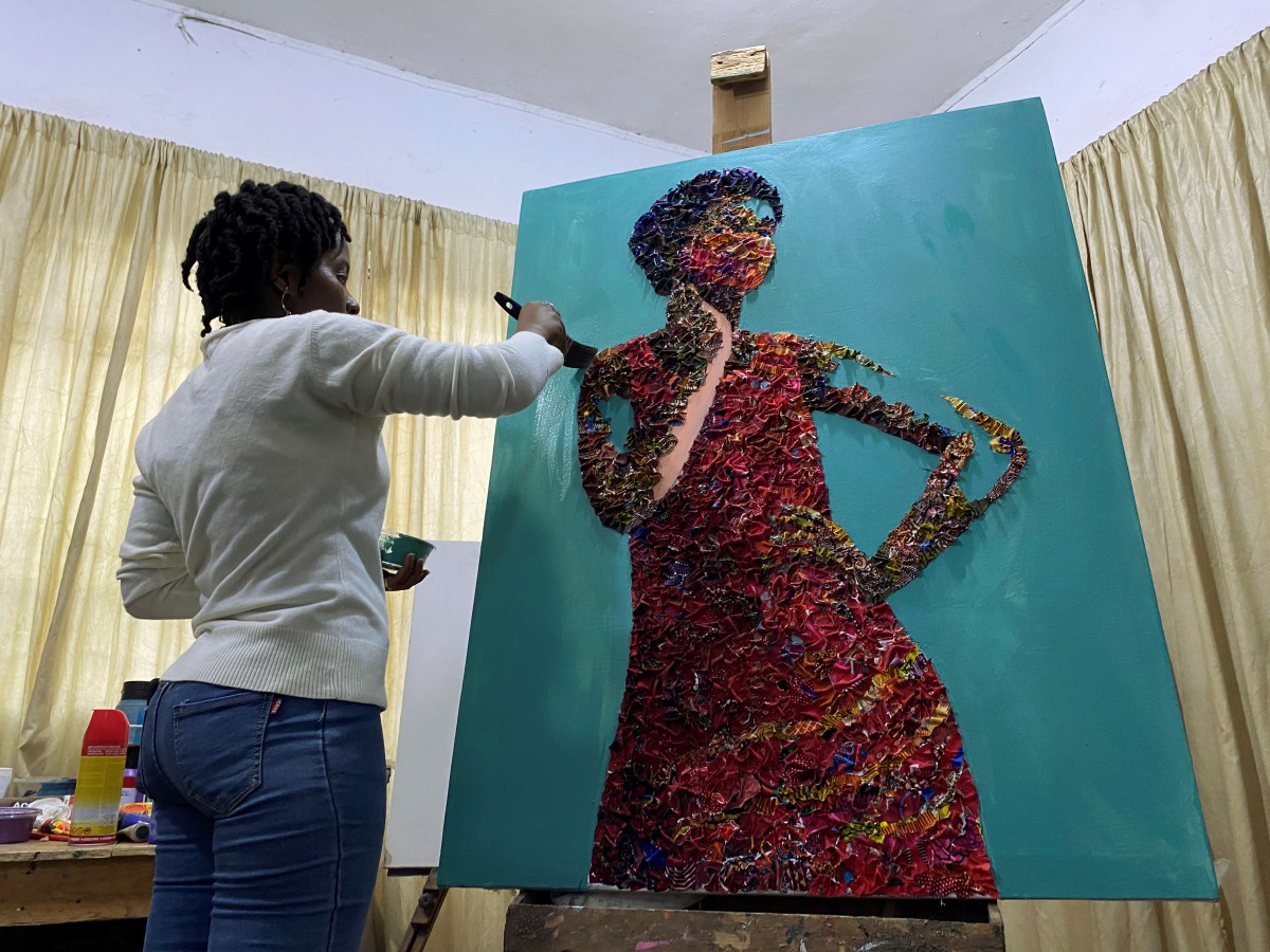 Marcellina Akpojotor creates an art piece of a woman with a face mask using waste Ankara fabric in Lagos, Nigeria August 18, 2020. Picture taken August 18, 2020. REUTERS/Seun Sanni
