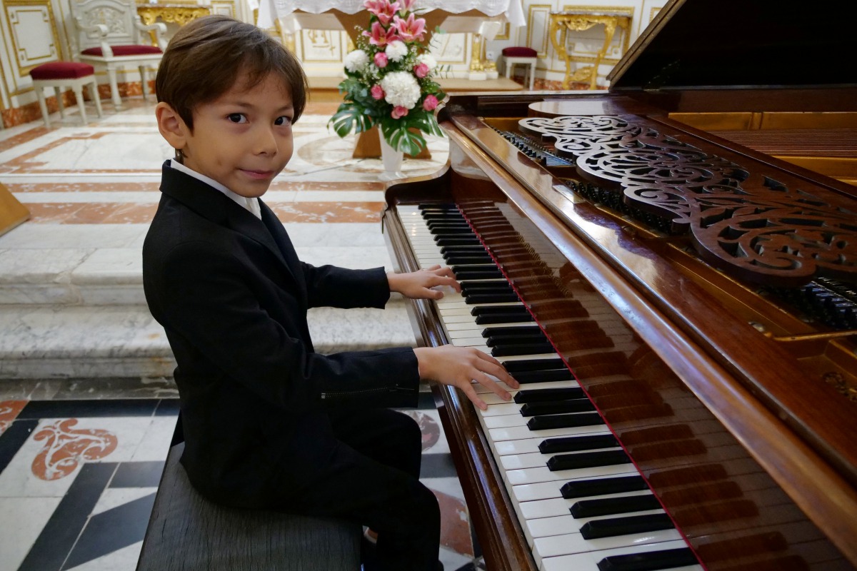 Guillaume Benoliel, a six-year-old child, plays the piano during a practice session in a church in Brunoy, France, October 5, 2020. Picture taken October 5, 2020. REUTERS/Noemie Olive
