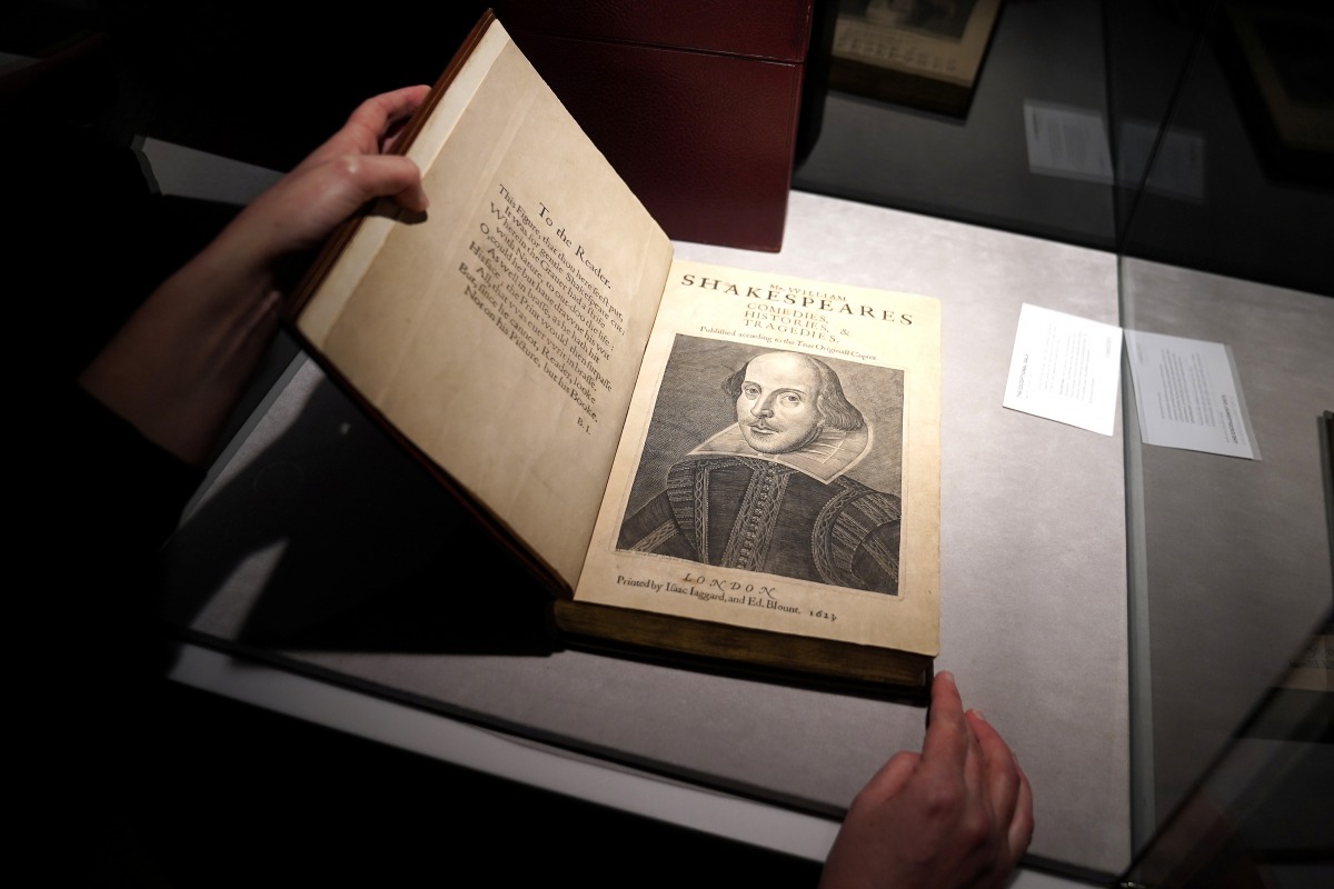An employee of Christie's auctions holds a 1663 rare first folio of 36 Shakespeare works that was sold for a record 8.4 million dollars (9.978 million with buyers fee) in the Manhattan borough of New York City, New York, U.S., October 14, 2020. REUTERS/Ca