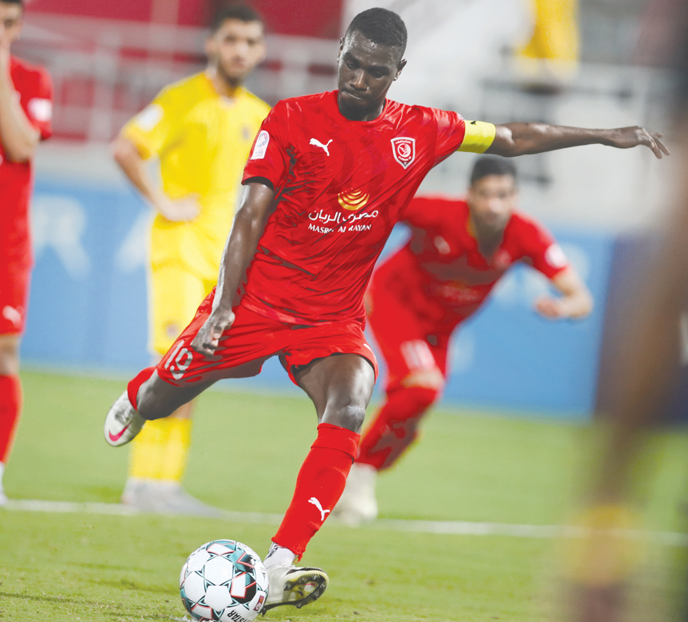 Al Duhail's captain Almoez Ali shoots to score against Qatar SC during yesterday's match. 