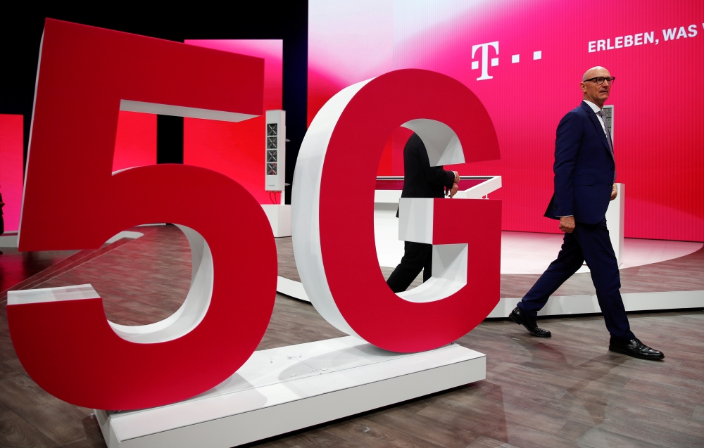 File photo: Tim Hoettges, CEO of Deutsche Telekom AG, walks on stage past a 5G technology setup during the company's annual shareholder meeting in Bonn, Germany, March 28, 2019. Reuters/Wolfgang Rattay/File Photo