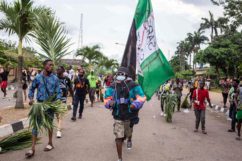 Protesters march at Alausa, the Lagos State Secretariat, in Lagos on October 20, 2020, after the Governor of Lagos State, Sanwo Olu, declared 24-hour curfew in Nigeria's economic hub Lagos as violence flared in widespread protests that have rocked cities 