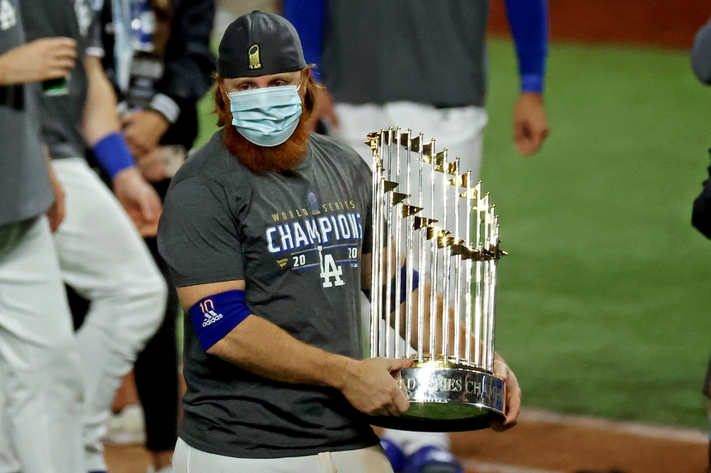 Los Angeles Dodgers third baseman Justin Turner (10) celebrates with the Commissioner's Trophy after the Los Angeles Dodgers beat the Tampa Bay Rays to win the World Series in game six of the 2020 World Series at Globe Life Field. Mandatory Credit: Kevin 