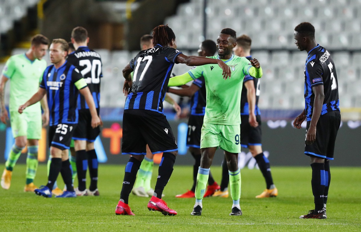Soccer Football - Champions League - Group F - Club Brugge v Lazio - Jan Breydel Stadium, Brugge, Belgium - October 28, 2020 Lazio’s Jean-Daniel Akpa Akpro and Club Brugge's Simon Deli after the match REUTERS/Francois Lenoir

