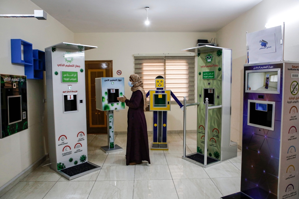 Palestinian entrepreneur Heba al-Hindi demonstrates a locally-designed and manufactured smart sterilisation device in Gaza City on October 8, 2020. AFP / MOHAMMED ABED