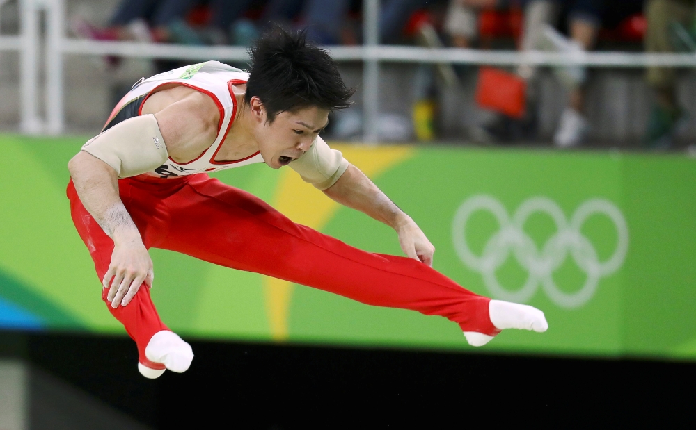 Kohei Uchimura (JPN) of Japan competes on the parallel bars during the men's individual all-around final. REUTERS/Kai Pfaffenbach