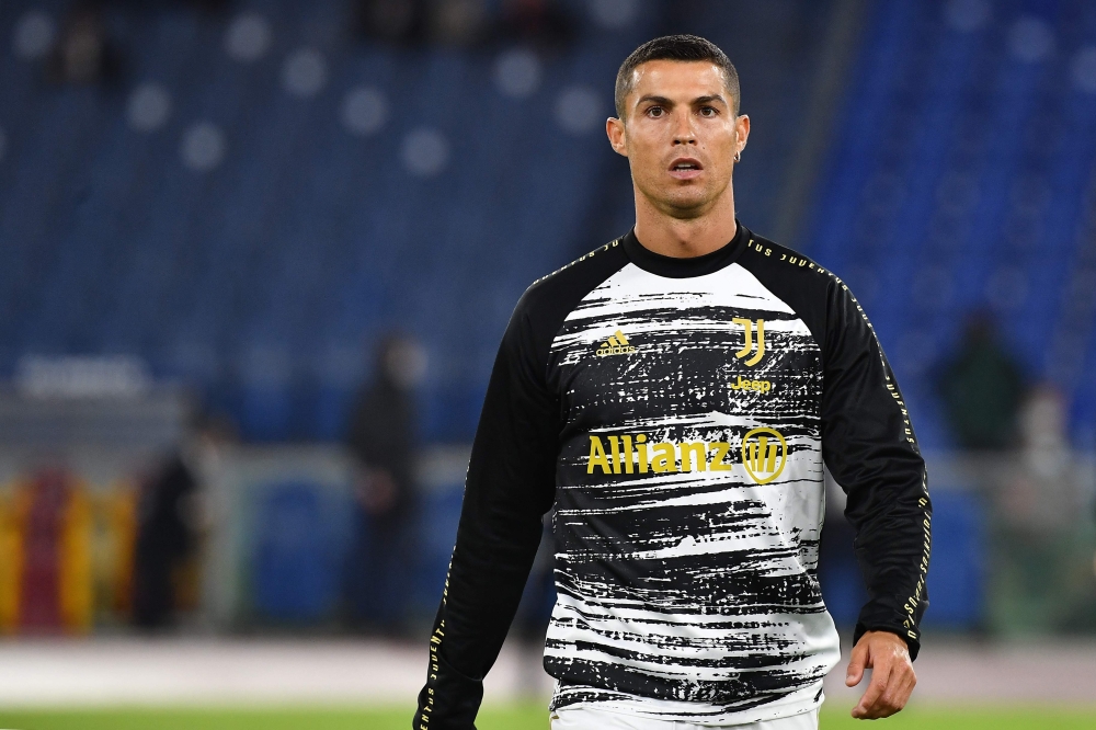 In this file photo taken on September 27, 2020 Juventus' Portuguese forward Cristiano Ronaldo warms up prior to the Italian Serie A football match Roma vs Juventus at the Olympic stadium in Rome.  / AFP / Tiziana FABI