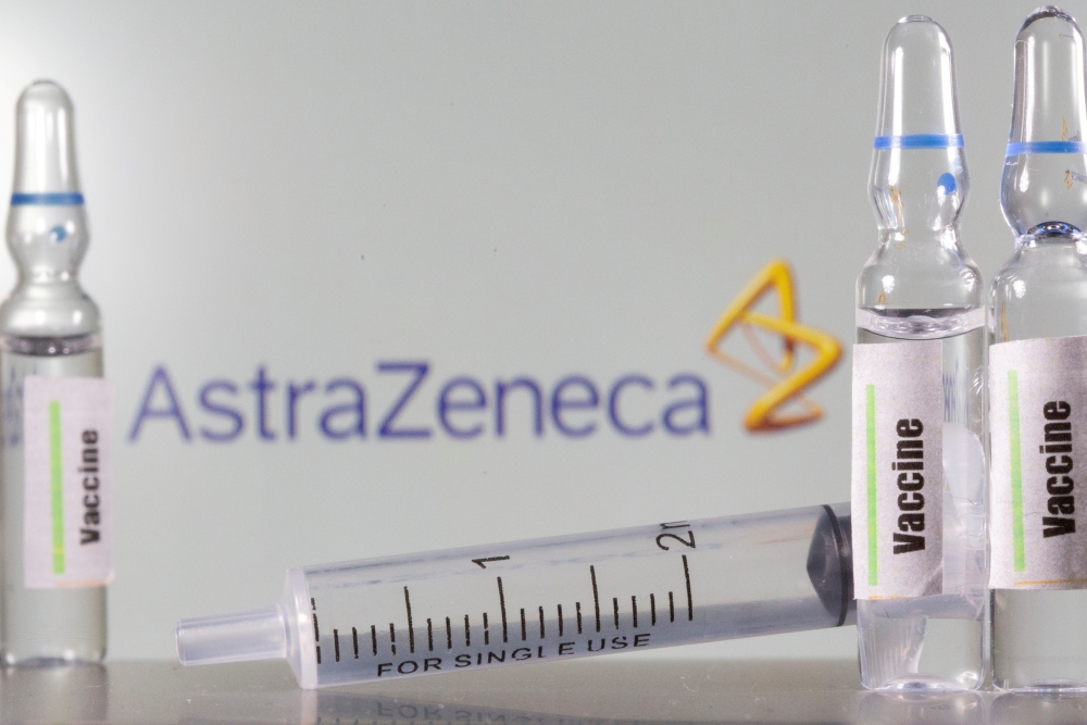 A test tube labelled with the Vaccine is seen in front of AstraZeneca logo in this illustration taken, September 9, 2020. REUTERS/Dado Ruvic/Illustration/File Photo