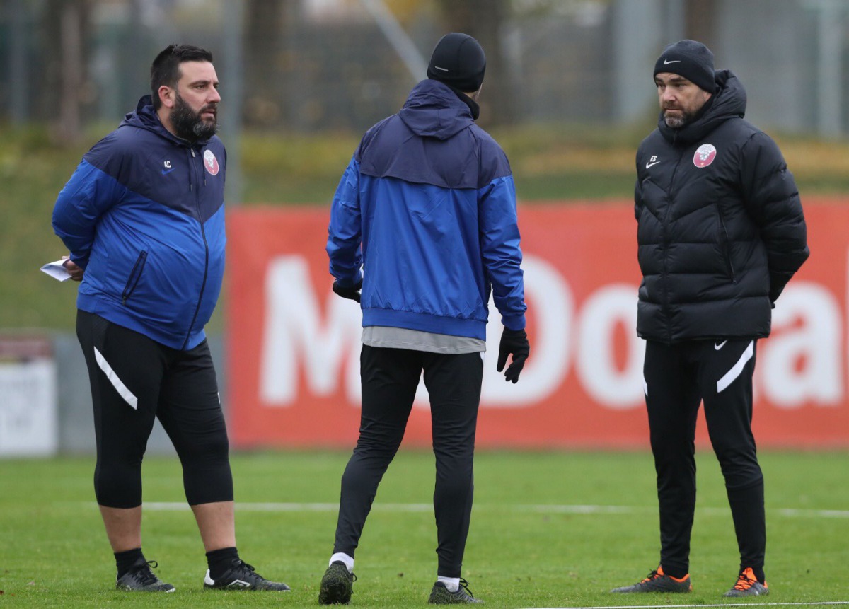 Qatar coach Felix Sanchez (right) and his assistants are all wrapped up in team trainers and jackets in Vienna, Austria, yesterday.  