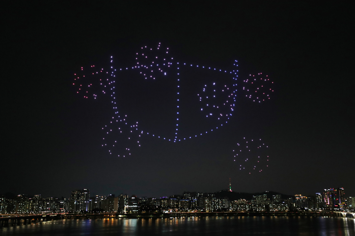 FILE PHOTO: Drones fly over the Han river showing messages to support the country, as measures to avoid the spread of the coronavirus continue, in Seoul, South Korea. Yonhap via REUTERS

