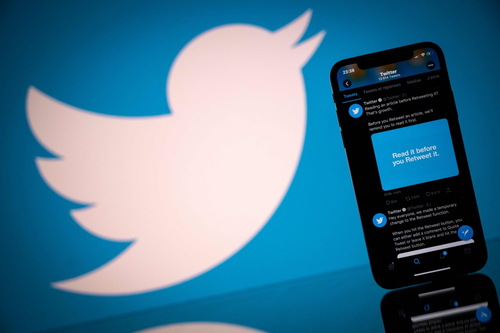 FILE PHOTO: The logo of US social network Twitter displayed on the screen of a smartphone and a tablet in Toulouse, southern France. AFP / Lionel BONAVENTURE