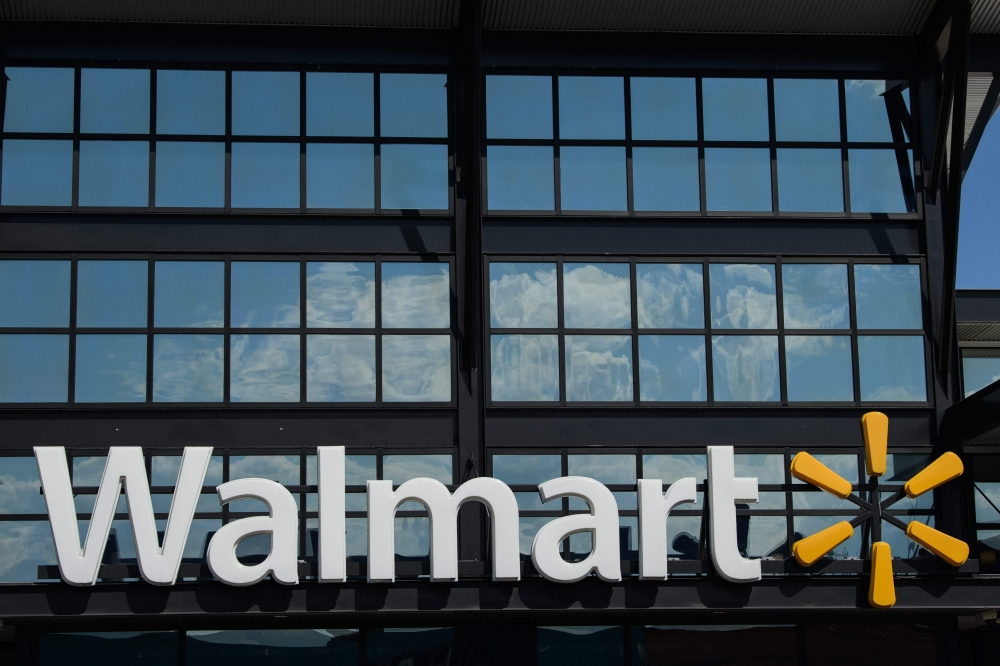 In this file photo taken on August 18, 2020 a Walmart logo is seen outside a store in Washington, DC. Walmart reported another strong quarter on November 17, 2020, pivoting during the coronavirus pandemic, with more consumers shifting to e-commerce and sh