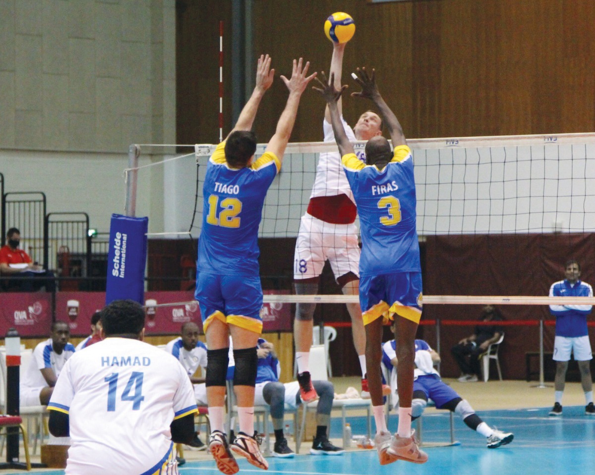 An Al Khor player smashes the ball to score against Al Gharafa during their match. 