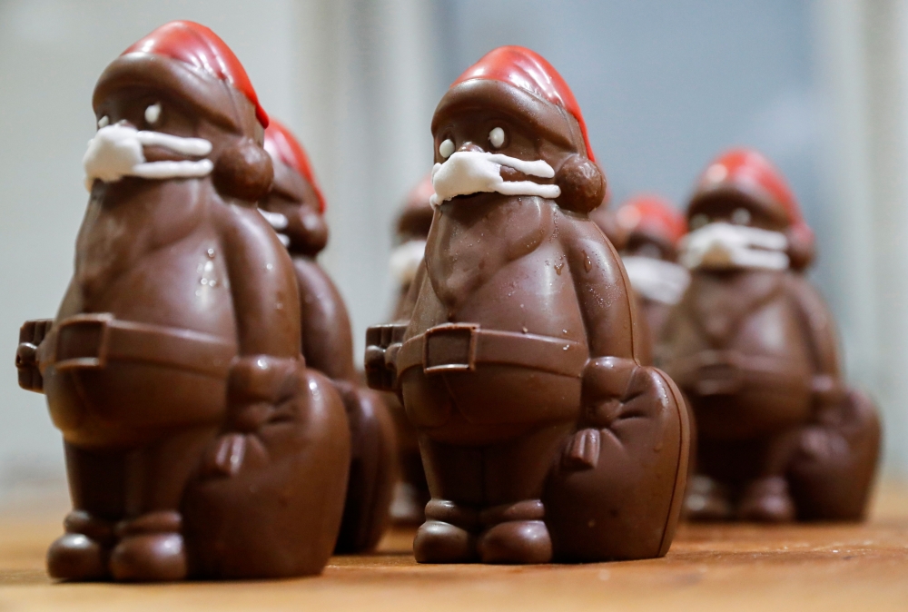 Chocolate Santas wearing protective face masks are seen in the workshop of the Hungarian confectioner Laszlo Rimoczi, during the coronavirus disease (COVID-19) outbreak in Lajosmizse, Hungary, November 20, 2020. Reuters/Bernadett Szabo