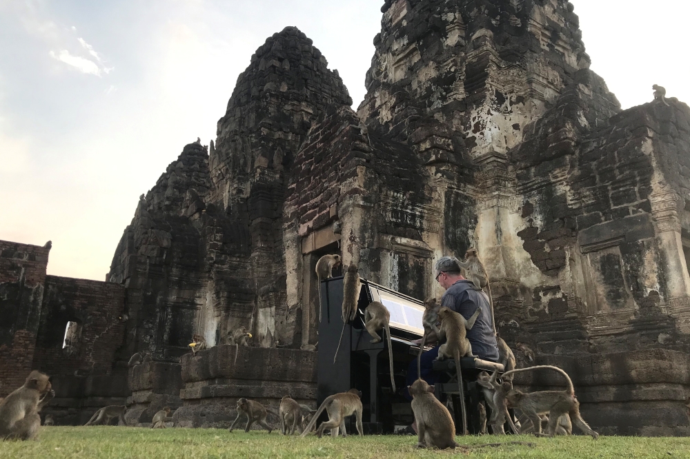 British musician Paul Barton plays the piano for monkeys that occupy abandoned historical areas in Lopburi, Thailand November 21 2020. Reuters/Prapan Chankaew