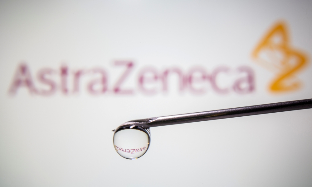 FILE PHOTO: AstraZeneca's logo is reflected in a drop on a syringe needle in this illustration taken November 9, 2020. REUTERS/Dado Ruvic/Illustration