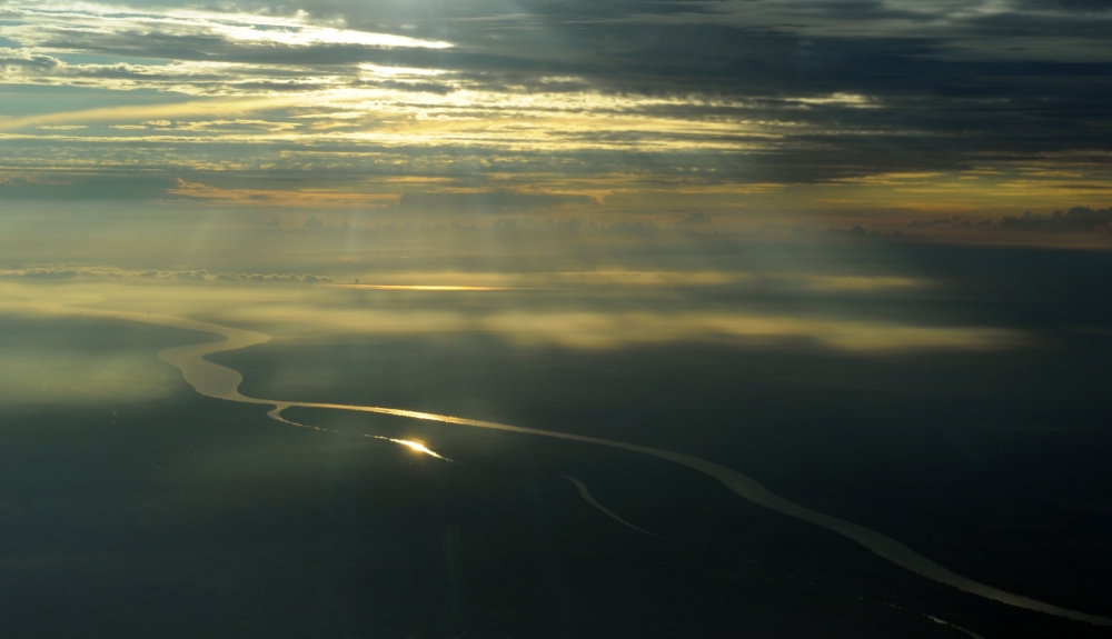 In this file photo taken on August 05, 2010 In this photograph taken on August 5, 2010 during an aerial inspection organized by Greenpeace, the sun rises over Jambi province in Sumatra island. Greenhouse gases in the atmosphere, the main driver of climate