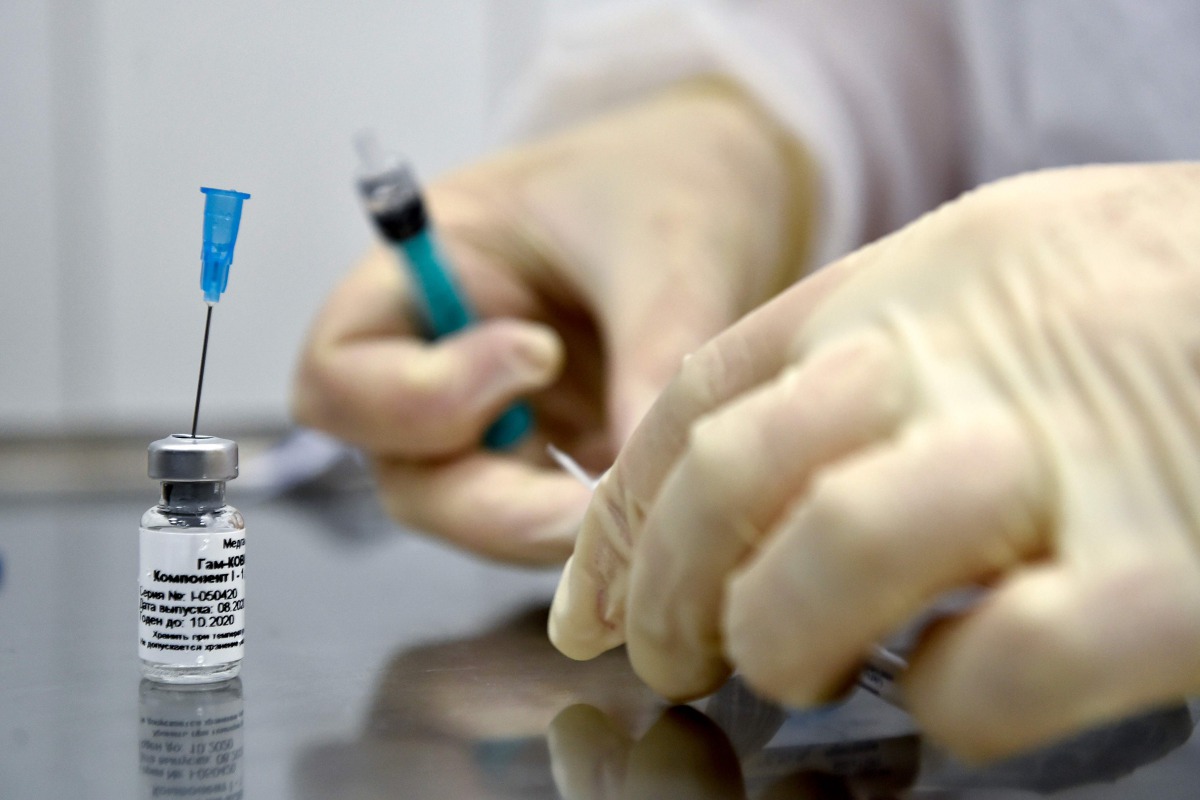 (FILES) In this file photo taken on September 10, 2020 a nurse prepares to inoculate volunteer Ilya Dubrovin, 36, with Russia's new coronavirus vaccine in a post-registration trials at a clinic in Moscow. Russia's Sputnik V coronavirus vaccine is 95 perce