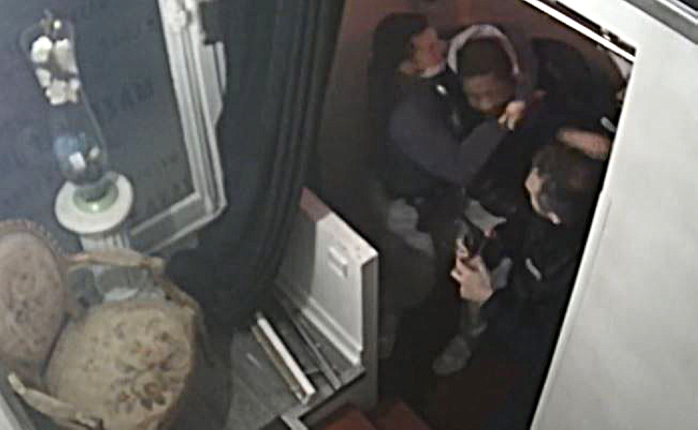 This video grab taken on November 27, 2020 from an AFP video shows CCTV camera footage, widely distributed on social networks, shows producer Michel Zecler being beaten up by police officers at the entrance of a music studio in the 17th arrondissement of 