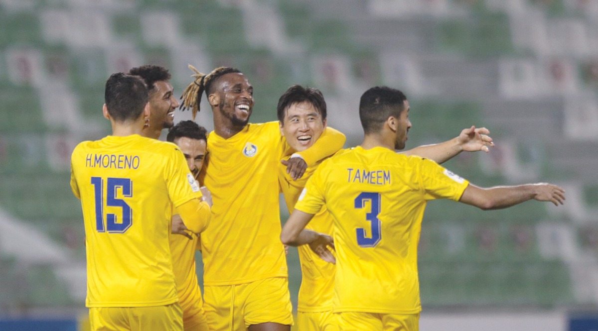 Al Gharafa players celebrate after defeating Al Ahli yesterday.