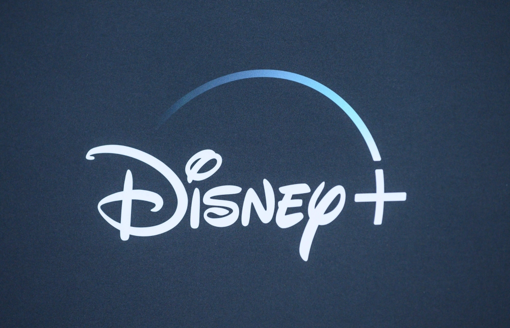 In this file photo taken on November 13, 2019 the Disney+ logo is seen on the backdrop for the World Premiere of 