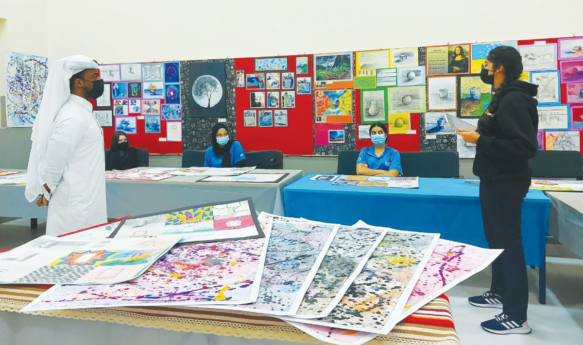 Students share their artworks with Qatari artist Mohammed Faraj Al Suwaidi. 