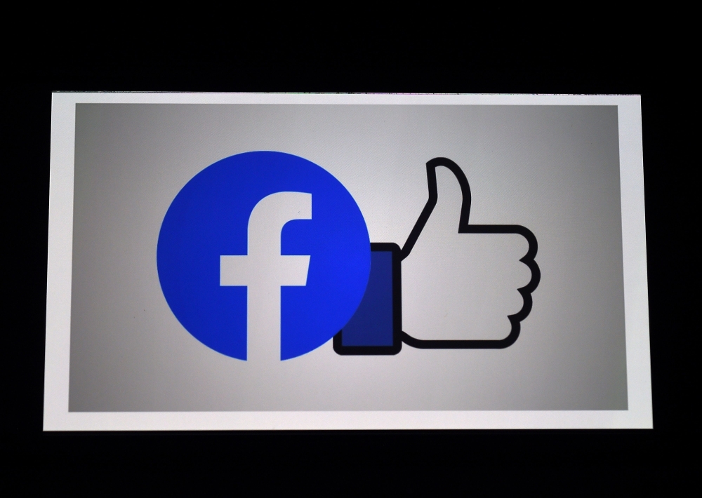 FILE PHOTO: A Facebook App logo is displayed on a smartphone on March 25, 2020 in Arlington, Virginia.  AFP / Olivier DOULIERY