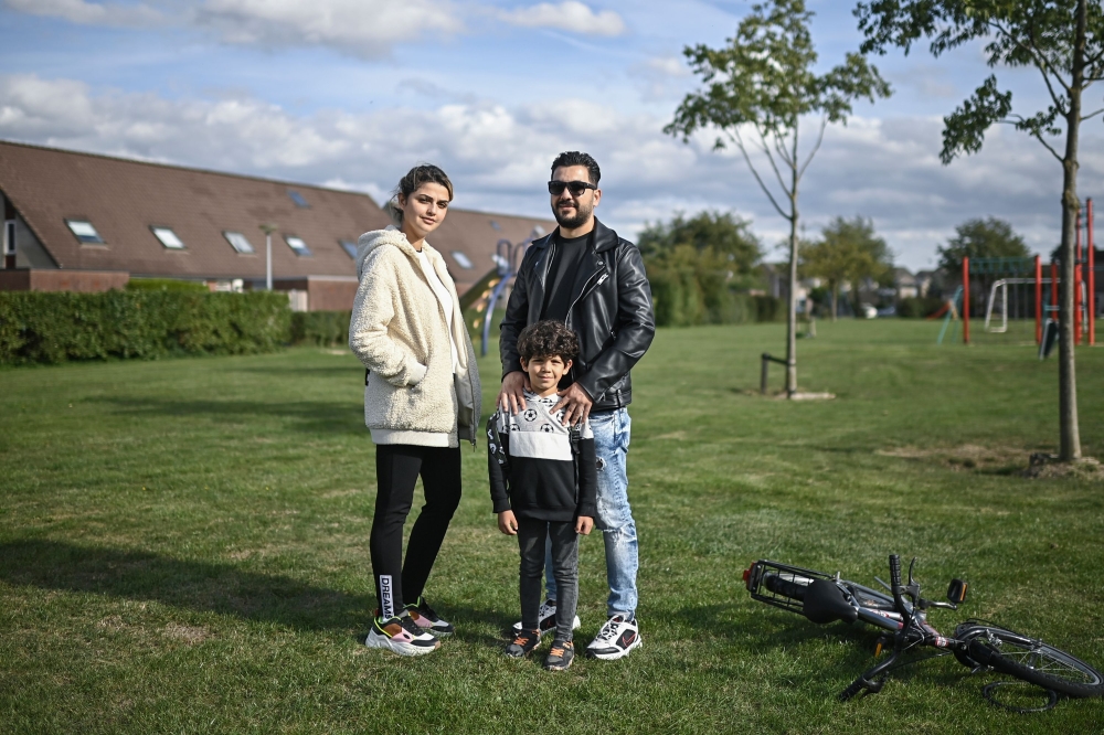 In this photograph taken on September 24, 2020, 32 year-old Ahmad (R) with his wife Alia and their five year old son Adam pose standing in a park in the town of Duiven, The Netherlands. (AFP / ARIS MESSINIS)