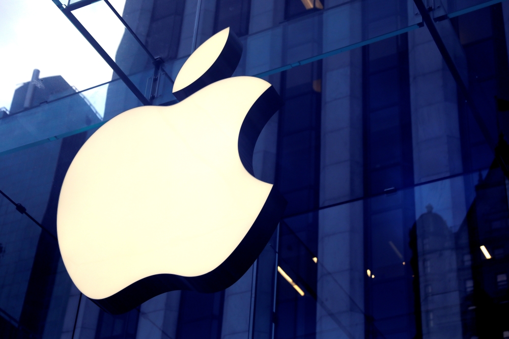 FILE PHOTO: The Apple Inc logo is seen hanging at the entrance to the Apple store on 5th Avenue in Manhattan, New York, U.S., October 16, 2019. REUTERS/Mike Segar/File Photo
