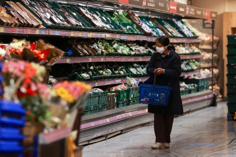 A woman shops at an Aldo store, amid the coronavirus disease (COVID-19) outbreak, Balham, London, Britain December 22, 2020. Reuters/Hannah McKay