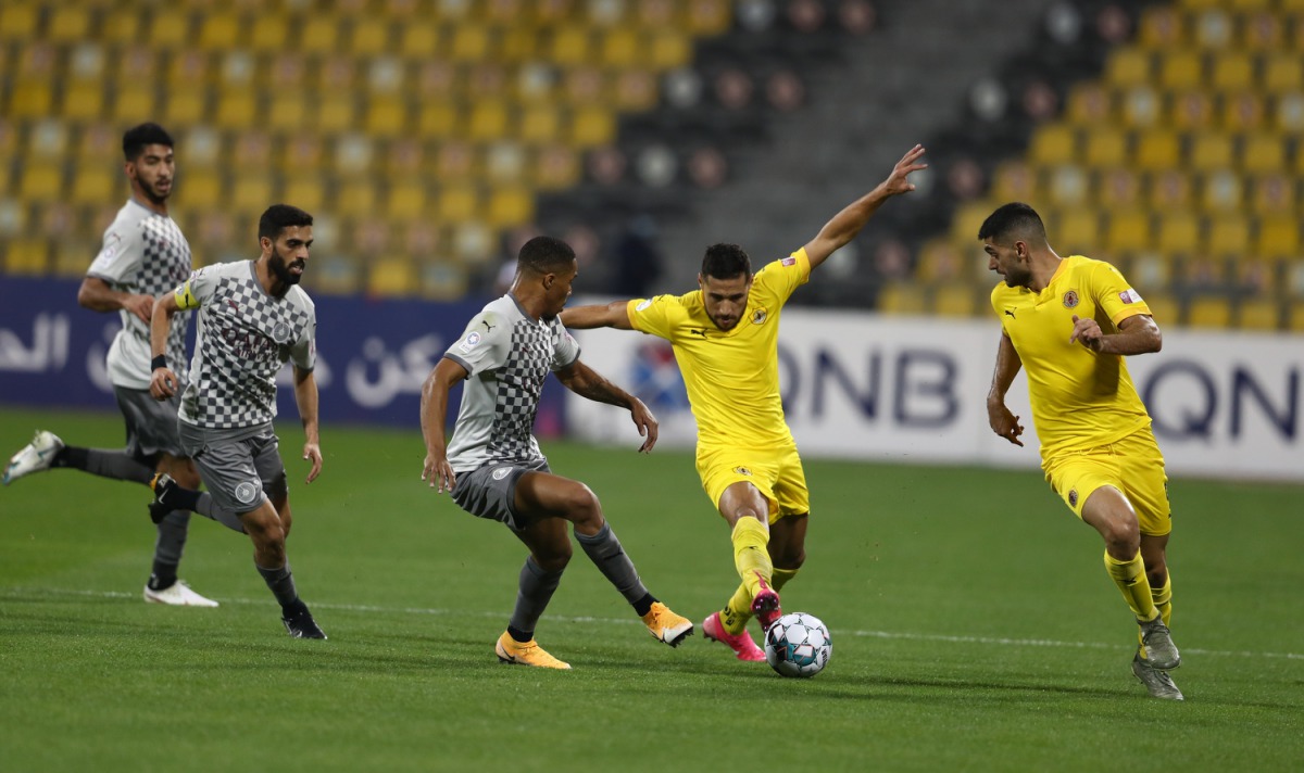 Qatar SC's Mohammed Youcef Belaili (second right) is challenged by Al Sadd's Pedro Miguel during yesterday's QNB Stars League Round 11 match played at Qatar SC Stadium.
